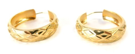 A pair of 9ct gold hoop earrings, each with bark effect and cross hoop hammered detailing, stamped 375, 2.5cm wide, 3.1g.