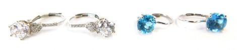 Two pairs of drop earrings, to include a 9ct white gold and blue topaz set drop earrings, 2cm high together with a pair of silver and CZ set drop earrings, 4.7g all in.