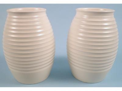 A pair of Wedgwood Keith Murray cream glazed vases with ribbed decoration