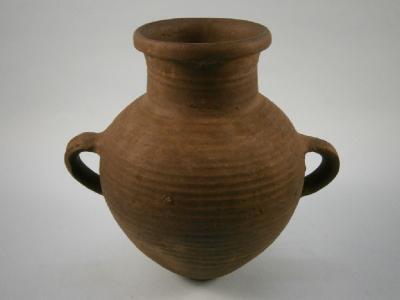 A two-handled matt-glazed coil pot: By repute Assyrian and from 600BC