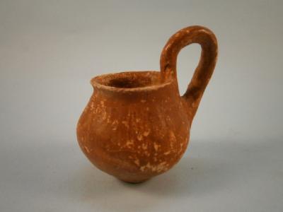 A terracotta coloured pottery wine dipper: By repute Cypriot and dating from 4000BC