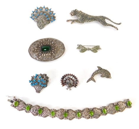 A group of silver and marcasite set jewellery, to include a silver and marcasite set leopard brooch, 10cm wide, a silver turquoise coloured stone and marcasite set basket brooch, 3cm wide, similar peacock brooch, 5cm wide, a garnet set silver peacock broo