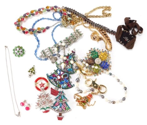 A group of costume jewellery, elaborate stone set brooches, lizard brooch, handbag clips, silver plated and stone set bracelets, etc. (1 tin)