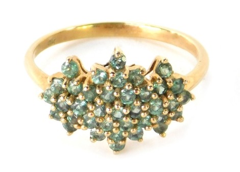 A 9ct gold dress ring, with light green set three point stone cluster, in claw setting, ring size P½, 2.6g.