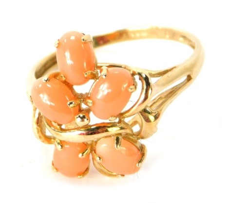 A 9ct gold cluster dress ring, set with five oval pale orange stones in a raised basket setting, Q½, 2.4g all in.