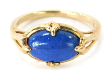 A 9ct gold lapis set dress ring, with oval lapis in four claw setting with pierced design shoulders, ring size P½, 3.1g.