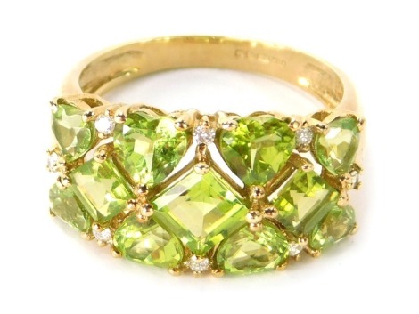 A 9ct gold dress ring, the central panel set with heart and square cut peridot, and tiny set diamonds, in raised claw setting, ring size Q½, 4.2g all in.