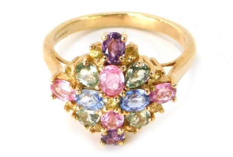 A 9ct gold semi precious stone set dress ring, the central cluster set with pink, blue, green and yellow semi precious stones, on a layered design, ring size P, 3.9g all in.