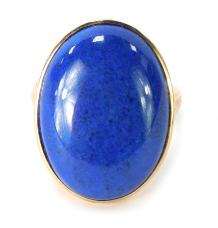 A 9ct gold lapis dress ring, the oval lapis in a raised basket rub over setting, ring size P½, 7.6g all in.