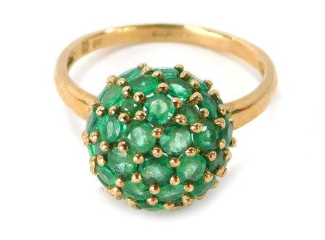 A 9ct gold emerald cluster ring, the central cluster ball set with round brilliant cut emeralds in a claw setting, ring size O, 3.8g all in.