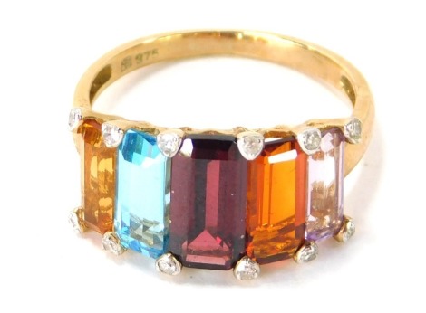 A 9ct gold five stone dress ring, set with five semi precious stones, yellow, light blue, red, orange and purple, with outer tiny diamond set points, on a yellow metal band, ring size P½, 3g all in.