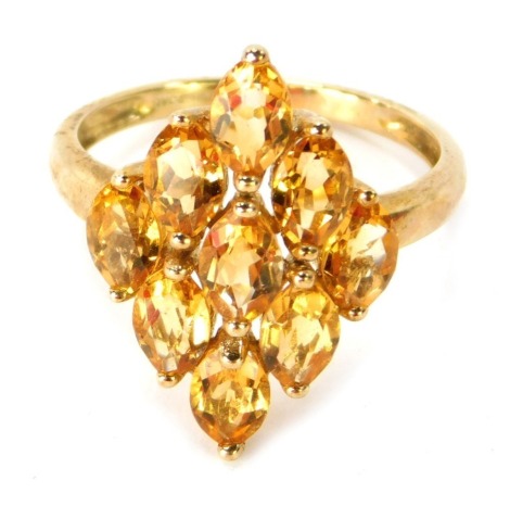 A 9ct gold dress ring, the diamond shaped centre design formed of nine oval cut citrines, in a raised basket claw setting, ring size P, 3.3g all in.