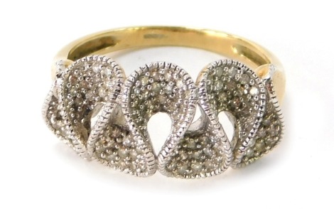 A 9ct gold dress ring, the central wave design in white gold set with tiny diamonds pave set on a yellow metal band, ring size P½, 3.6g all in.