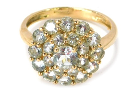 A 9ct gold cluster dress ring, on three layer design set with aquamarines in gold claws, ring size P½, 3.4g.