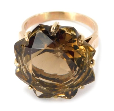 A 9ct gold smoky quartz dress ring, the central faceted stone forming an eight point flower in claw and back basket setting, ring size P, 8.7g all in.