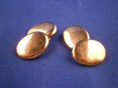 A pair of 18ct gold oval cuff links of plain form