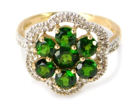 A 9ct gold floral cluster dress ring, the central peridot cluster with outer halo of tiny diamonds in a white gold setting on a yellow metal band, ring size P, 3.7g all in.