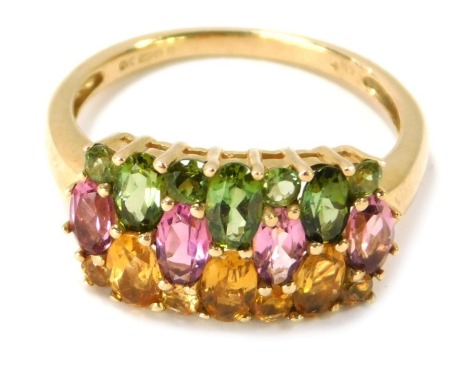 A 9ct gold half hoop dress ring, the central panel with three layers of semi precious coloured stones, citrines, pink topaz and peridot, raised basket claw setting, ring size Q½, 3.7g all in.