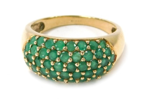 A 9ct gold half hoop eternity ring, set with round brilliant cut emeralds, in claw setting, ring size P½, 3.9g all in .