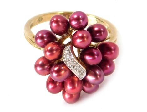 A 9ct gold cultured pearl cluster ring, the pearls with red/pink lustre on a central panel set with four tiny diamonds, ring size Q, 4.9g all in.