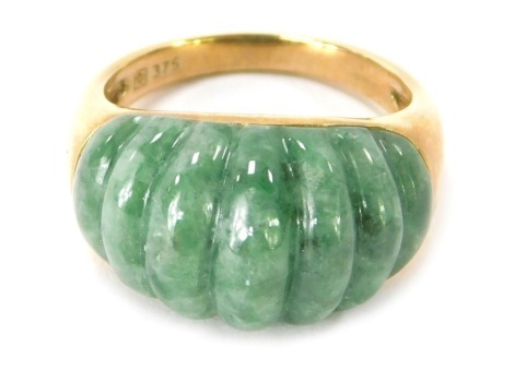 A 9ct gold jade set dress ring, the ribbed design jade in rub over setting, ring size P, 6.6g all in.