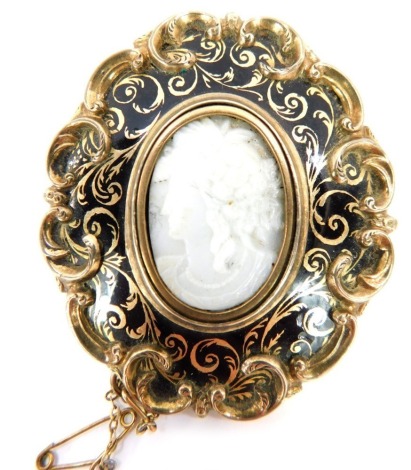 A late 19thC memorial brooch, the heavy scroll detailed and blackened outer border, with a central oval crest depicting maiden, in blue and gold with single pin back and safety chain, 6cm x 5cm, 41.8g all in.