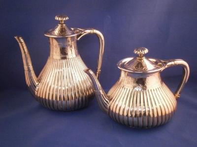 A Victorian silver coffee pot and teapot of part fluted form