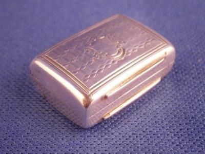 A small rectangular silver vinaigrette