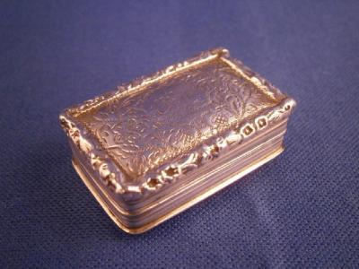 A William IV rectangular silver vinaigrette engraved with flowers and a