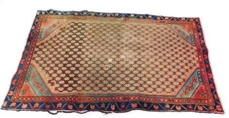 A Persian rug, with an all over design of guls, with two narrow borders 153cm x 89cm. (AF)