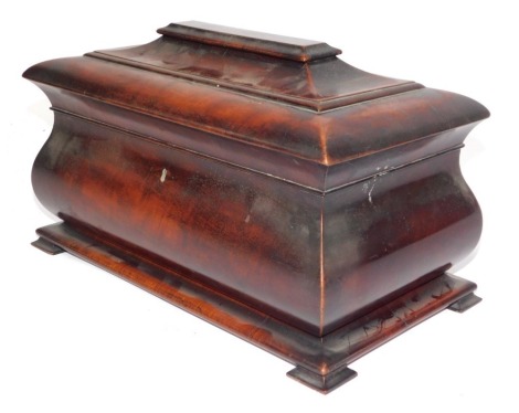 A William IV flame mahogany sarcophagus shaped tea caddy, the moulded top opening to reveal a fitted interior with central bowl section and two lidded tea canisters, 22cm high, 39cm wide, 22cm deep.