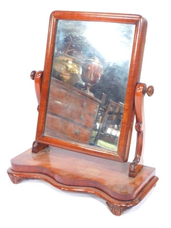 A Victorian mahogany swing frame toilet mirror, on a serpentine base, 52cm high, 46cm wide, 20cm deep.