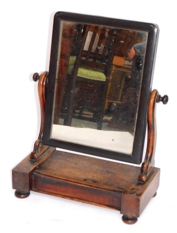 A Victorian mahogany swing frame toilet mirror, the rectangular mirror plate on lift lid base, on bun feet, 55cm high, 44cm wide, 20cm deep.