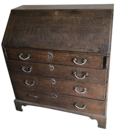 A George III oak bureau, with fall flap revealing a fitted interior over four graduated drawers with bracket feet, 92cm wide.