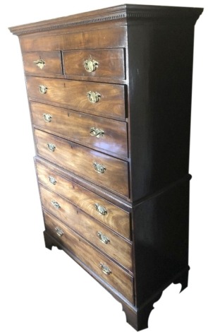 A George III tallboy, or chest on chest, with dentil moulded cornice an arrangement of two over three graduated drawers to the upper part and three to the base, each with replacement solid brass backplate swan neck handles and bracket feet, 172cm high, 11