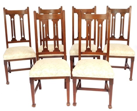 A set of six oak Arts & Crafts dining chairs, each with a diamond back in cream and gold leaf upholstered seats.