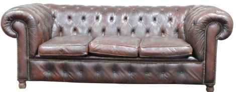 A Chesterfield brown leather three seater sofa, 70cm high, 206cm wide, 85cm deep. The upholstery in this lot does not comply with the 1988 (Fire & Fire Furnishing) Regulations, unless sold to a known exporter or upholsterer it will be cut from the frame b