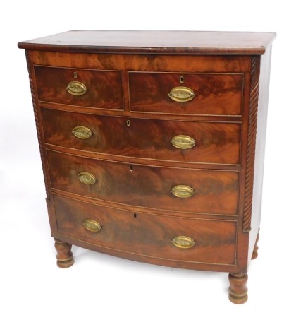 A Victorian bowfront mahogany chest, of two short and three long drawers, with brass floral escutcheons and carved sides, on turned feet, 116cm high, 102cm wide, 50cm deep.