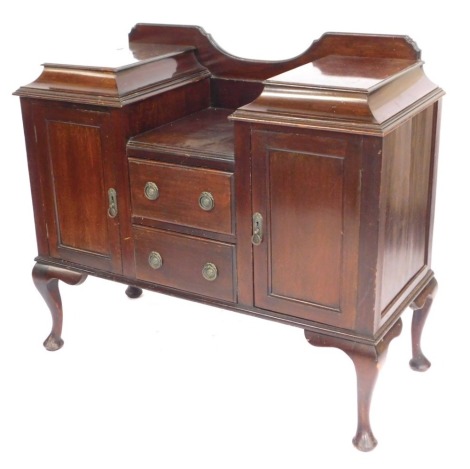 An Edwardian mahogany sideboard, with stepped top above two drawers and cupboard doors, on cabriole legs and pad feet, 112cm high, 116cm wide, 51cm deep.