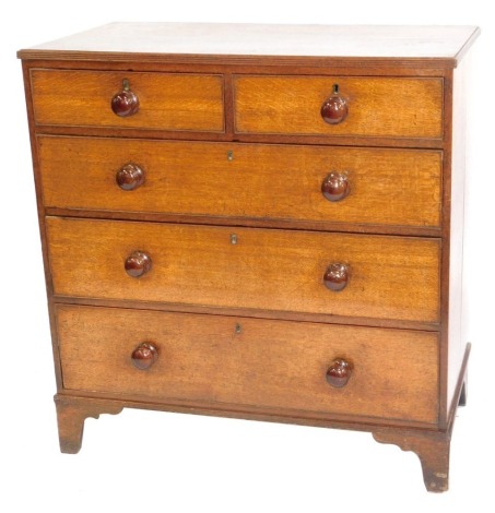 A George III oak chest, of two short and three long graduated drawers, with turned knob handles, and bracket feet, 100cm wide.