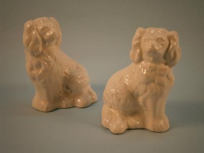 A pair of small Beswick pottery figures of white Spaniels