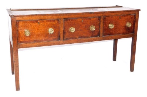 A 19thC cross banded oak and mahogany dresser base, with three drawers, 85cm high, 156cm wide, 54cm deep.