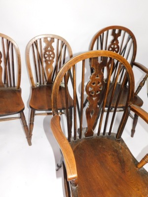 A set of four ash and elm Windsor chairs, including two carvers, each having wheel backs and triple ring turned forelegs. - 2