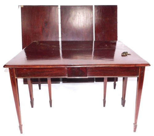 An Edwardian mahogany dining table, with rectangular ends on square taper legs with spayed feet, 131cm wide, 122cm minimum and two further leaves of a total 115cm extension.