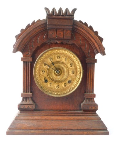 A late 20thC mahogany mantel clock, the arched pediment top on column supports, with a brass numeric dial, on a stepped foot, 36cm high, 29cm wide, 13cm deep.