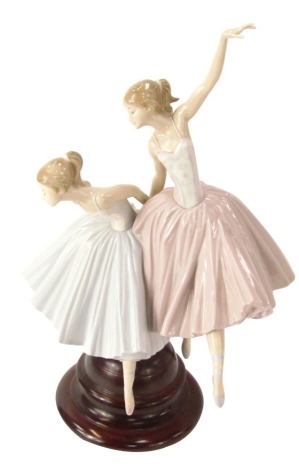 A Lladro ballerina figure group, of two ballerinas in blue and pink, on a wooden base, 49cm high.