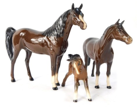 Royal Doulton and Beswick horses, comprising a Beswick foal, and two Royal Doulton brown horses. (3)