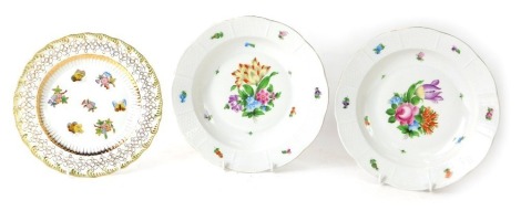 A pair of Herend of Hungary porcelain soup plates, with central decorated hand painted floral sprays and basket weave border, 24cm diameter, (AF). (2)