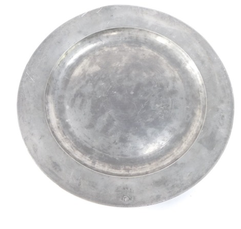 An 18thC pewter charger, indistinct marks, hole, 42cm diameter.