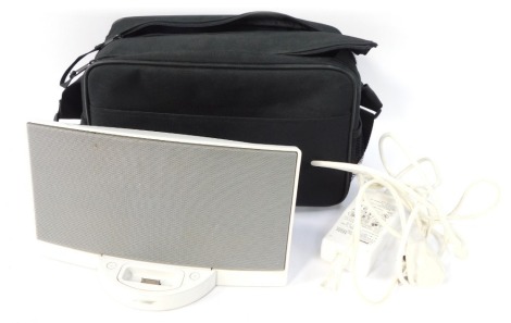 A Bose portable speaker, with carry case and cable.